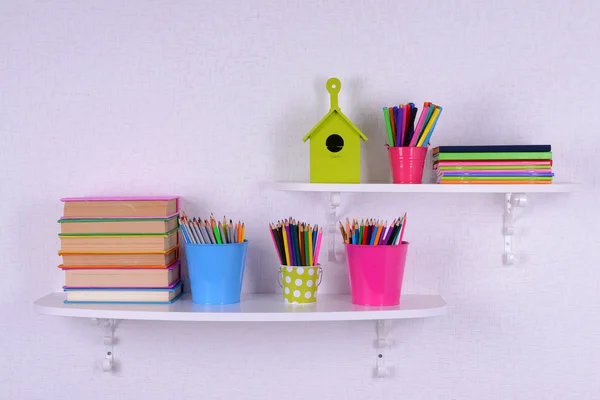 Shelves with stationery in child room — Stock Photo, Image