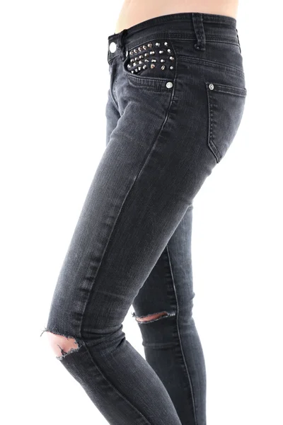 Girlish legs in torn jeans close up — Stock Photo, Image