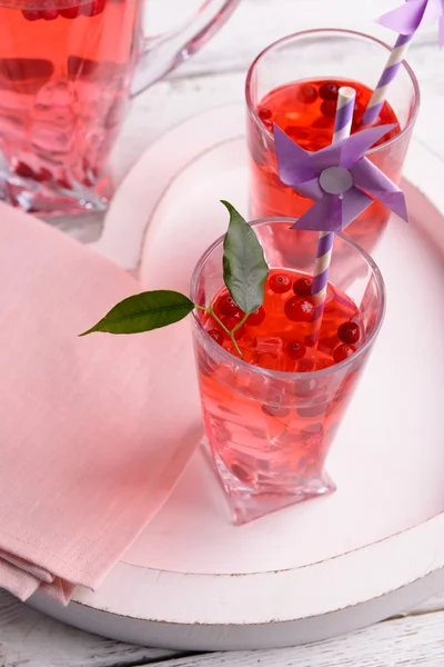 Compote with red currant in glassware on wooden tray, closeup — Stock Photo, Image