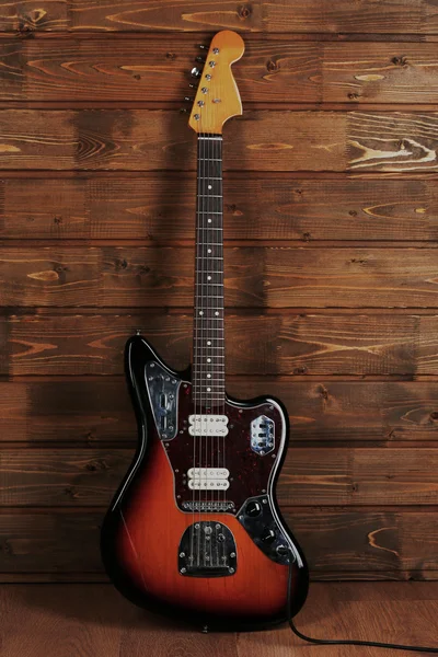 Electric guitar on wooden background — Stock Photo, Image