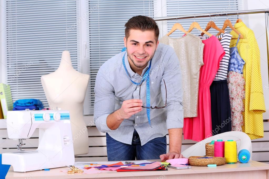 Young man fashion designer creates new collection of clothes 