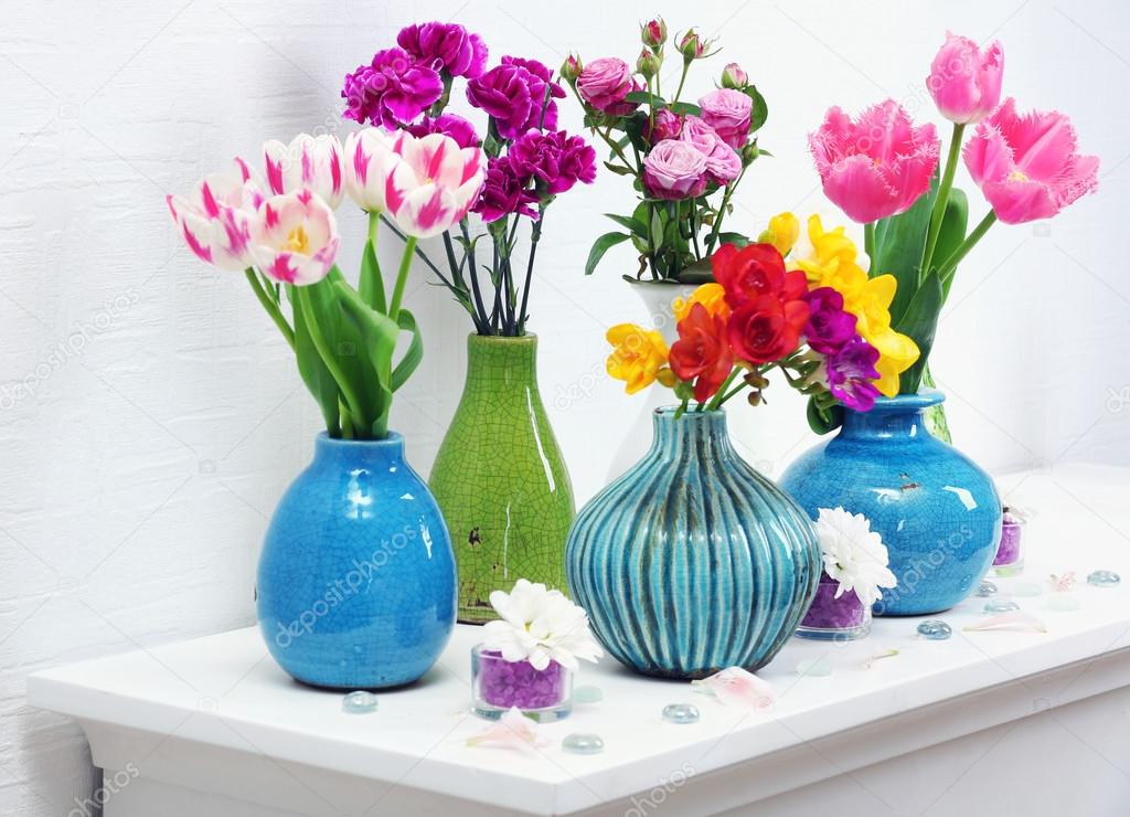 Composition with different flowers in vases