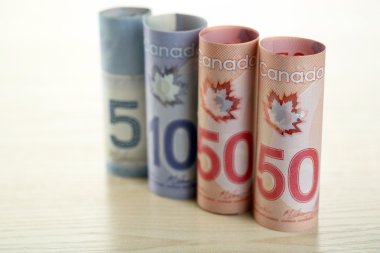 Canadian dollars on wooden table clipart