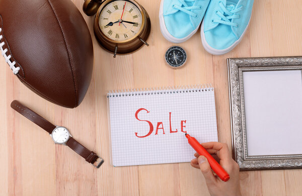 Sale unwanted stuff on wooden background top view