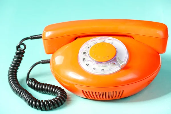 Retro red telephone on table on green background — Stock Photo, Image