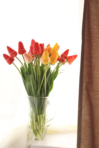 Bouquet of fresh tulips on windowsill — Stock Photo, Image