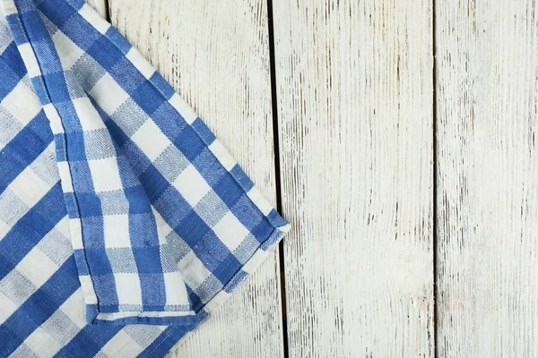 Checkered napkin on wooden table — Stock Photo, Image