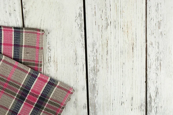 Checkered napkin on wooden table — Stock Photo, Image