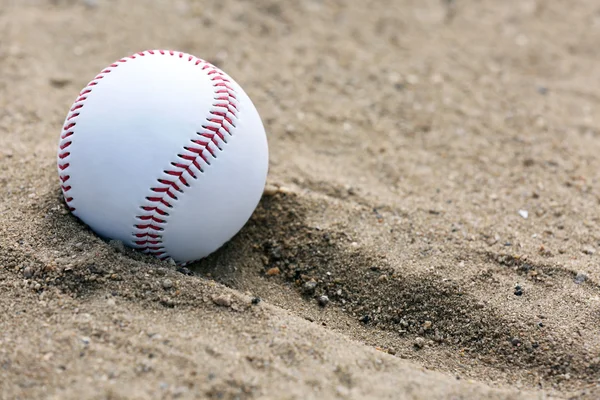 Baseball ball on sand