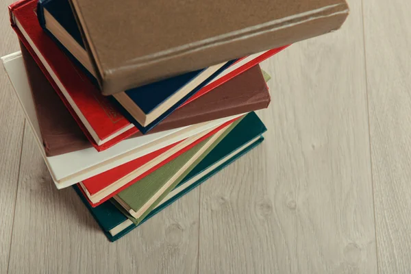 Stack of books on wooden background — Stock Photo, Image