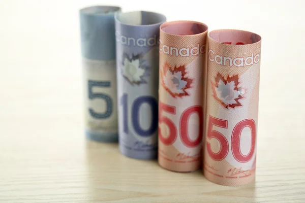 Canadian dollars on wooden table — Stock Photo, Image