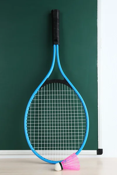 Tennis racket and shuttlecocks on blackboard background — Stock Photo, Image