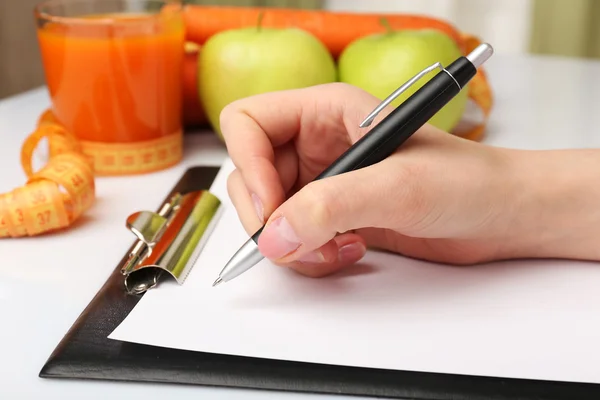 Nutritionist Doctor writing diet plan — Stock Photo, Image