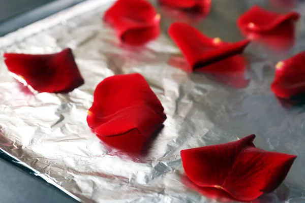 Roses petals on foil — Stock Photo, Image