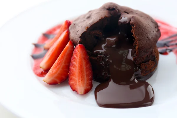 Chocolate fondant with strawberries on white plate, closeup — Stock Photo, Image