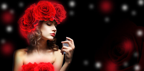 Beautiful woman with perfume bottle on dark background