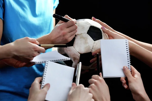 Autographs by football star on black and lights background