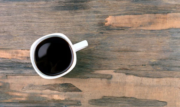 Taza de café sobre mesa de madera, vista superior — Foto de Stock