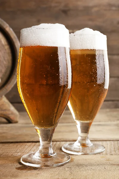 Glasses of beer on wooden background — Stock Photo, Image