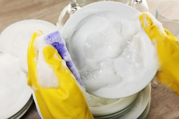 Female hand washing dish close up — Stock Photo, Image