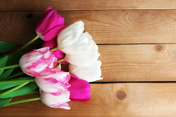 Beautiful tulips on wooden background — Stock Photo, Image