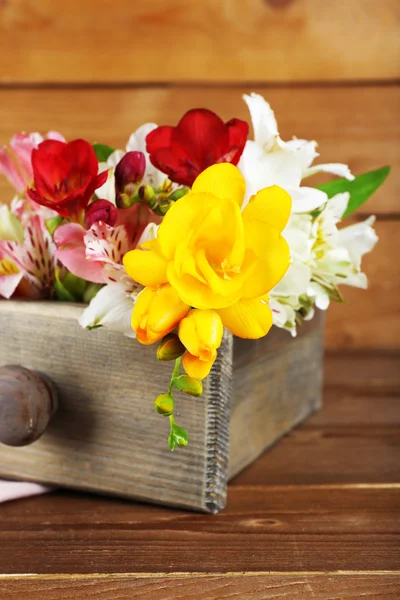 Beautiful spring flowers on wooden background — Stock Photo, Image