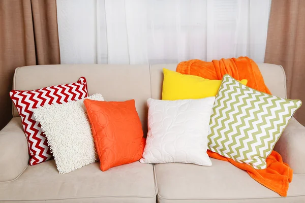 Диван с красочными подушками в номере — стоковое фото