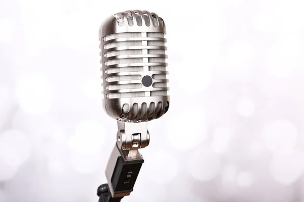 Retro microphone on bright blurred background — Stock Photo, Image