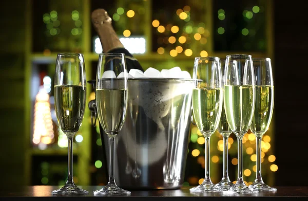 Glasses of champagne on bar background