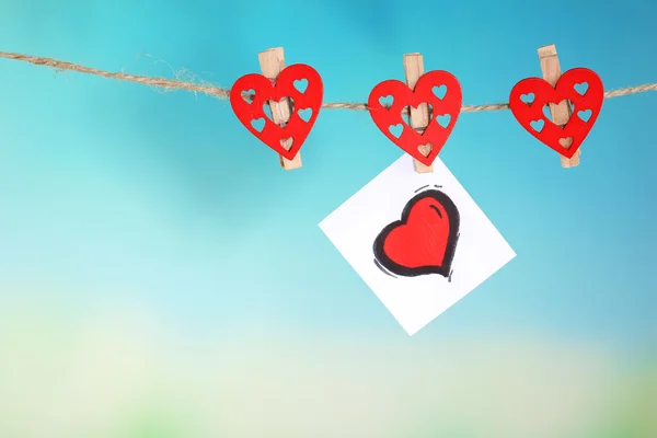 Hearts hanging on rope on bright background — Stock Photo, Image