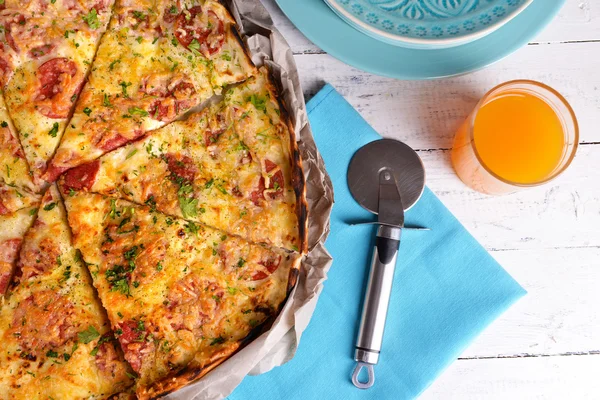 Tasty pizza with tableware on wooden table close up — Stock Photo, Image