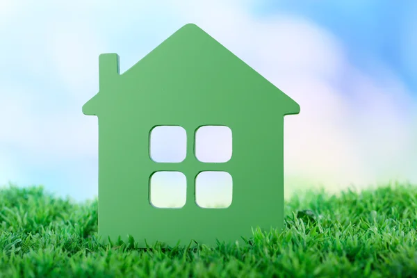 Toy house on grass on natural background — Stock Photo, Image