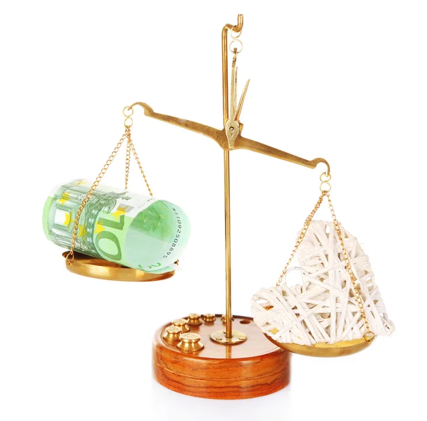 Money and heart in balance scales — Stock Photo, Image