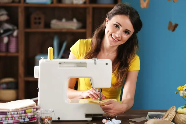 Beautiful young needlewoman — Stock Photo, Image