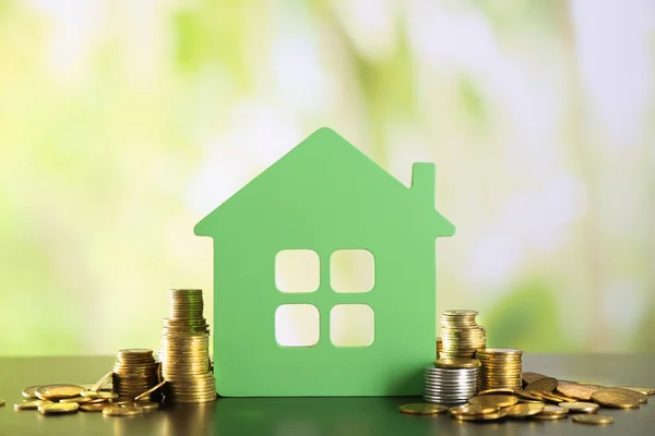 Model of house with coins — Stock Photo, Image