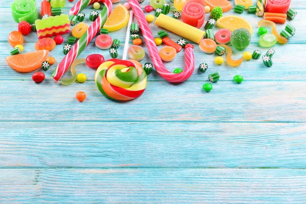 나무 배경에 있는 다채 로운 색깔의 사탕 — 스톡 사진