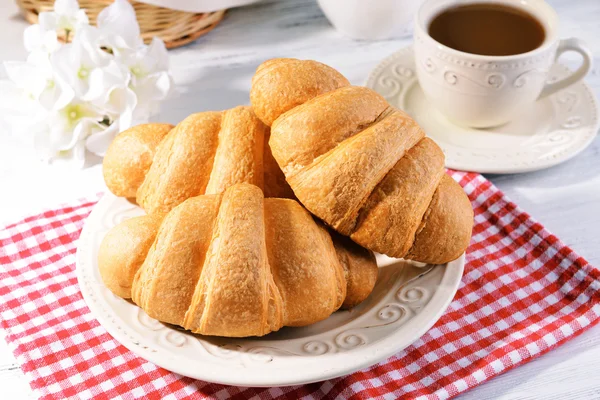 Delicious croissants on plate — Stock Photo, Image