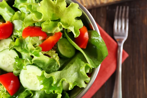 Färska grönsaker sallad i skål på bordet på nära håll — Stockfoto