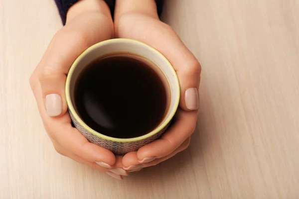 Female hands holding cup of coffee — Stock Photo, Image