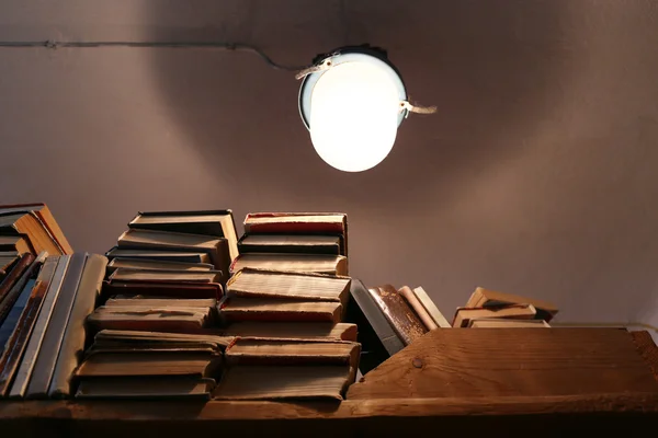 books on bookshelf with light bulb