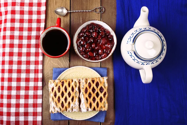Baking, tea and jam on wooden table top view — Stock Photo, Image