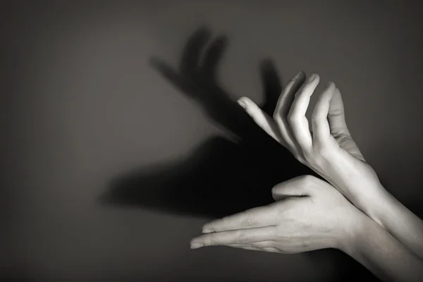 Hands gesture like deer on gray background — Stock Photo, Image