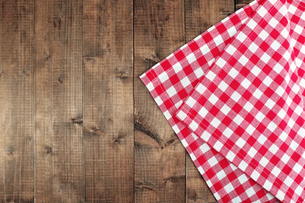 Checkered napkin on wooden table — Stock Photo, Image