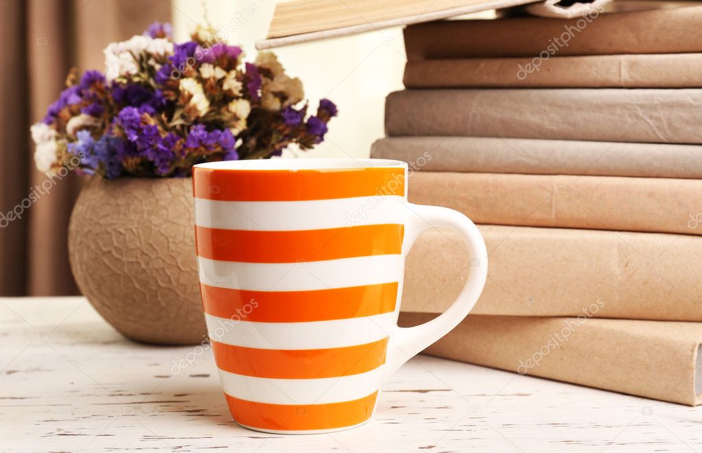 Books, cup and plant