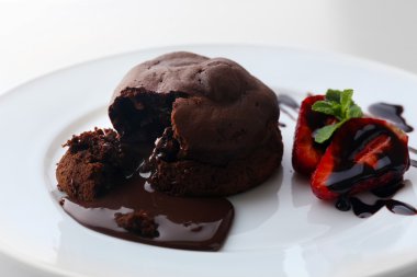 çilek beyaz tabakta, closeup ile Çikolatalı fondan