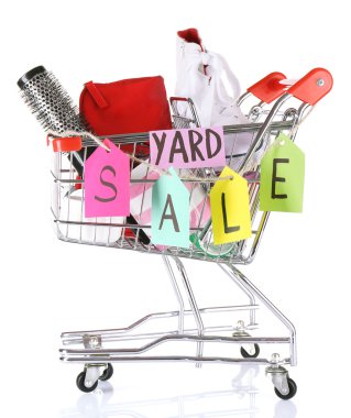 Shopping cart of unwanted stuff ready for yard sale isolated on white