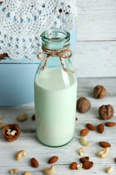 Melk in glaswerk en walnoten — Stockfoto