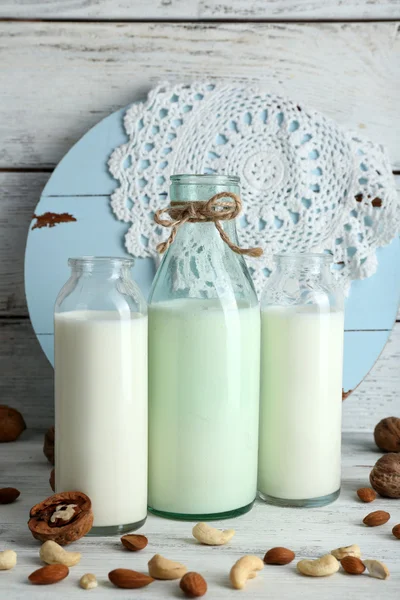 Milk in glassware and walnuts — Stock Photo, Image