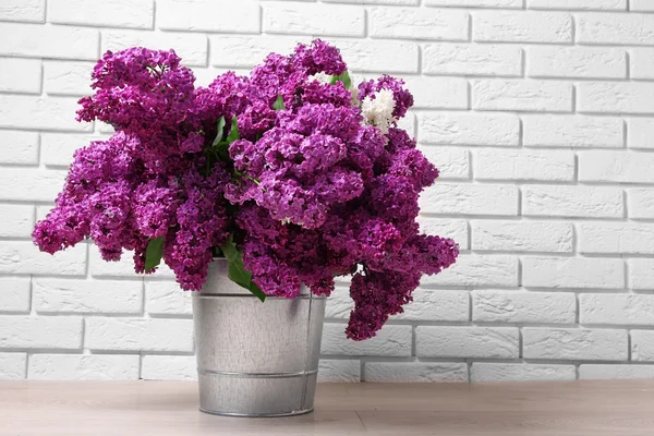 Beautiful lilac flowers in room — Stock Photo, Image