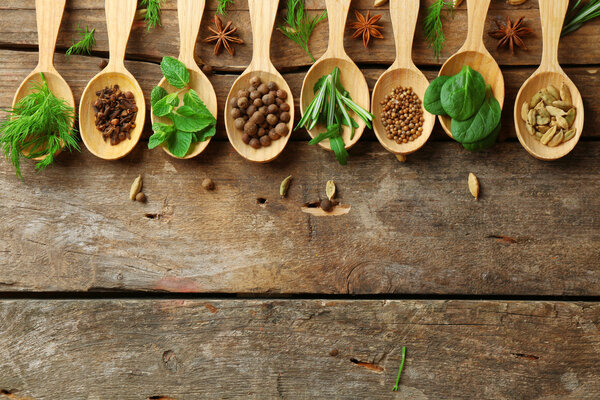 Wooden spoons with fresh herbs